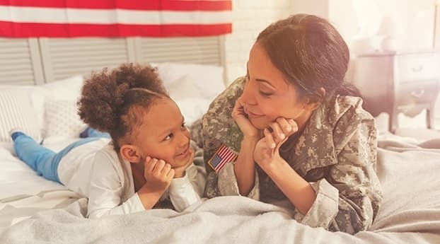 A veteran mother and her daughter looking at each other