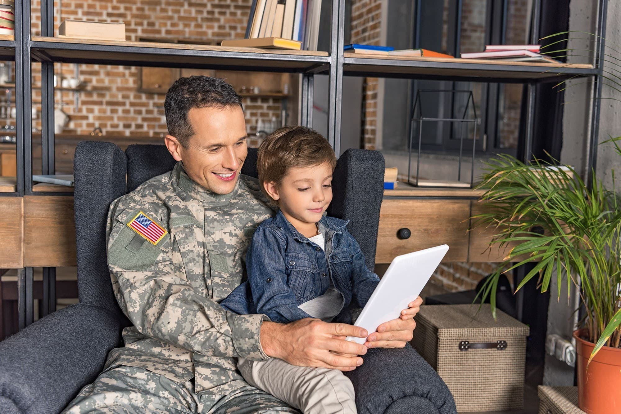 A veteran father reading to his son