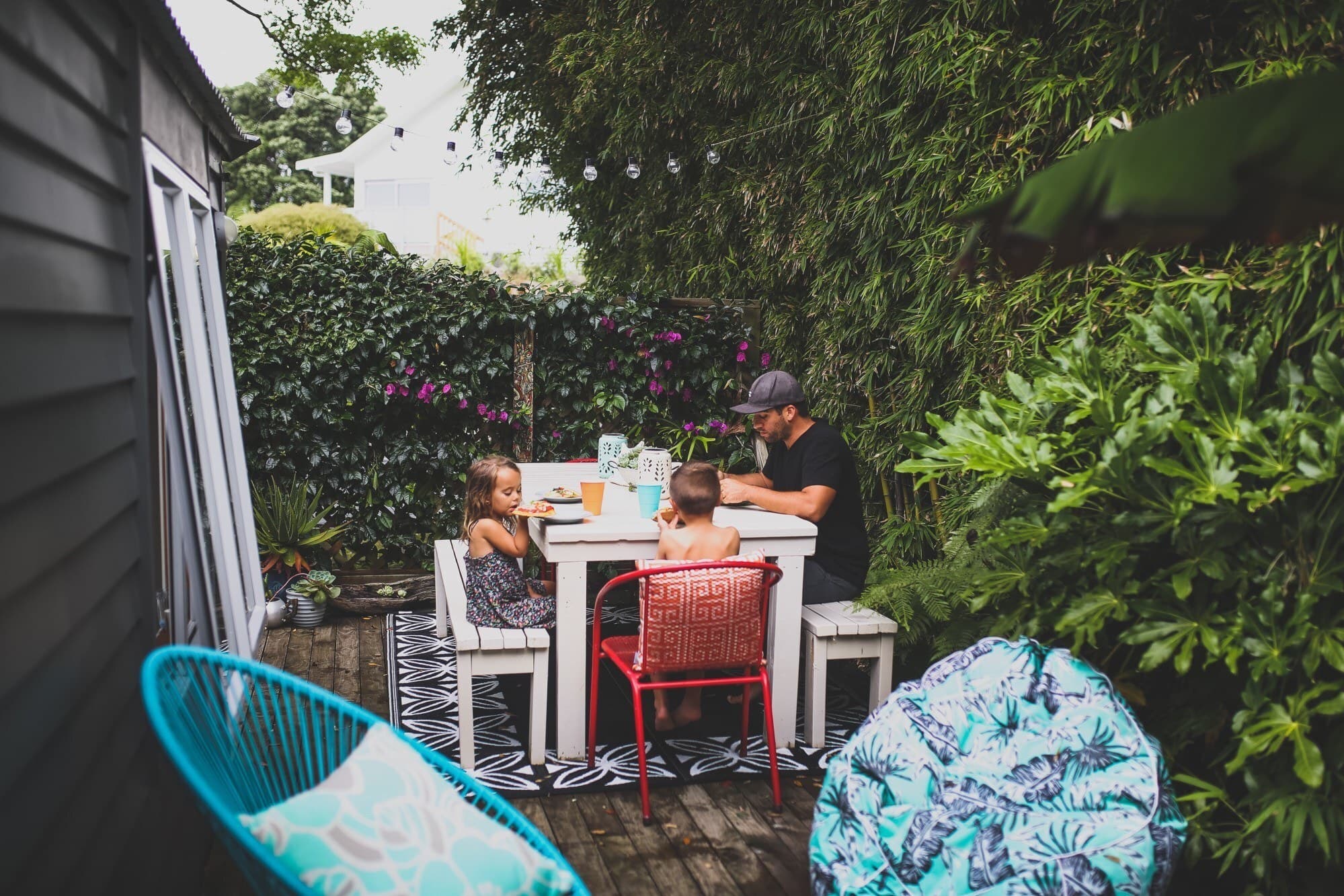 A young family eating in their backyard